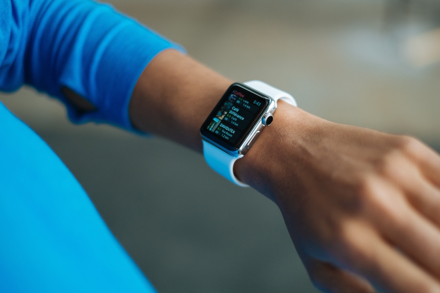 person wearing white silicone strap black smart watch 267394