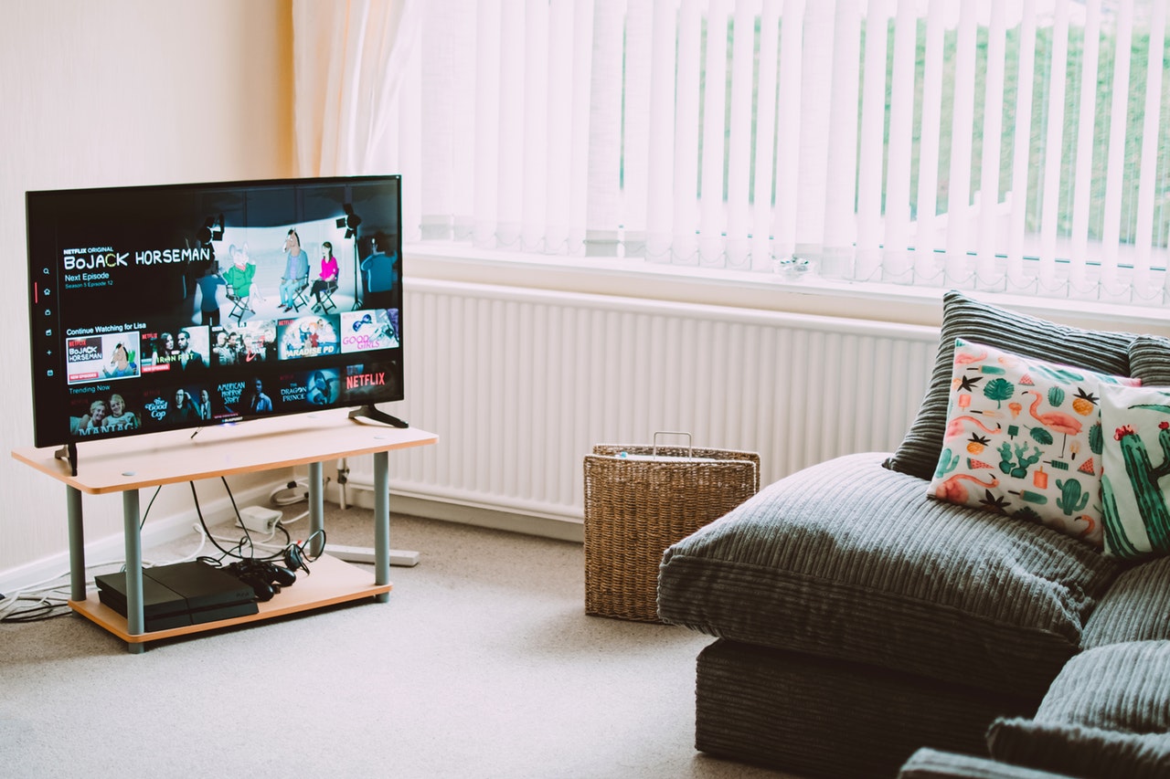 turned on flat screen smart television ahead 1444416