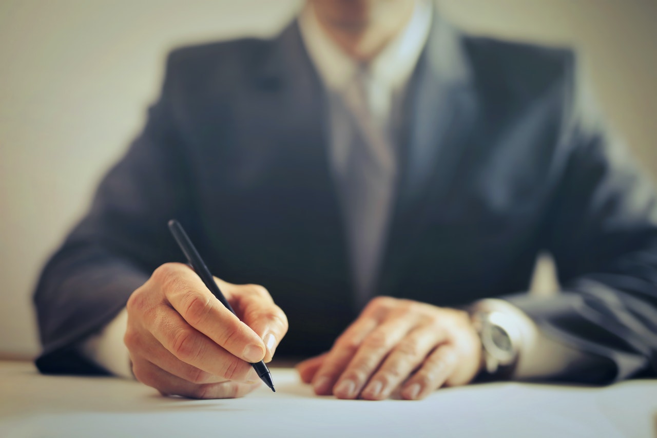 crop businessman signing contract in office 3771097