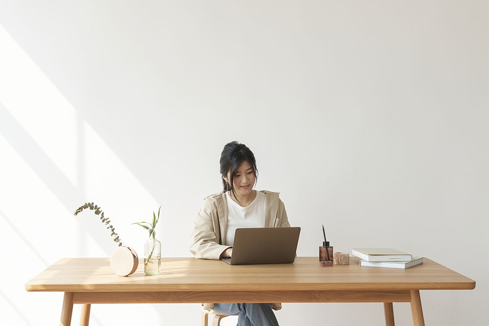 happy asian woman working from home 2023