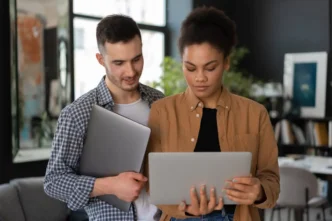 Two people holding grey tablets