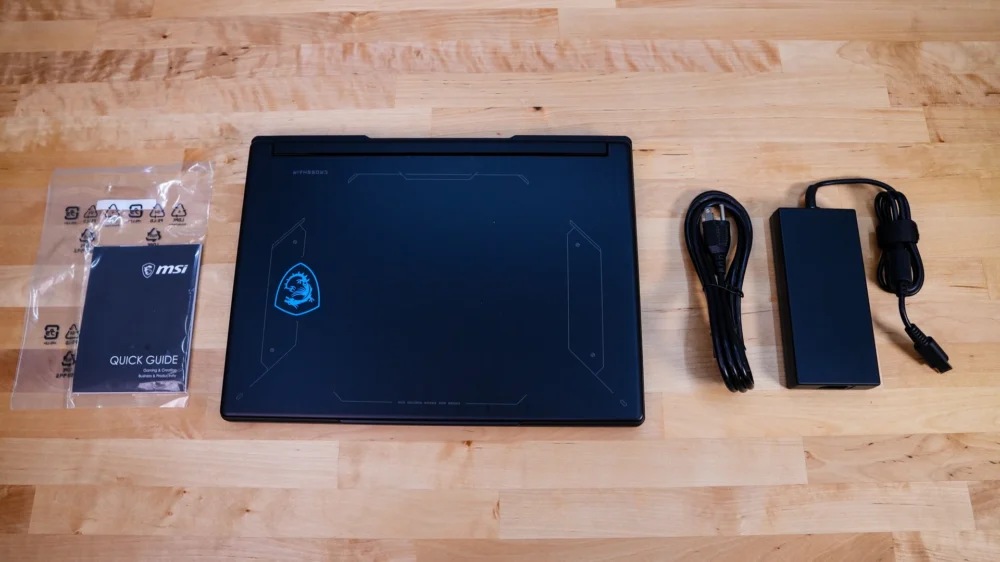 The MSI Crosshair 16 HX E14W comes with a power adapter, power cable, and a quick start guide